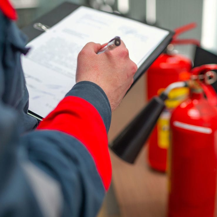 Engineer Professional are Checking A Fire Extinguisher Engineer Professional Checking A Fire Extinguisher