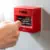 Person's fist punching a fire alarm