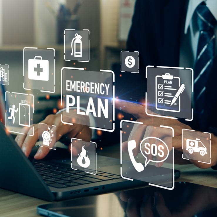 Someone on a laptop with a bunch of icons relating to fire risk assessments