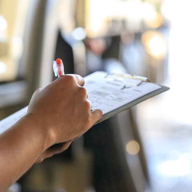 Someone with a clipboard completing a fire strategy