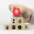 wooden toy blocks stacked with a red fire prevention icon being held by hand